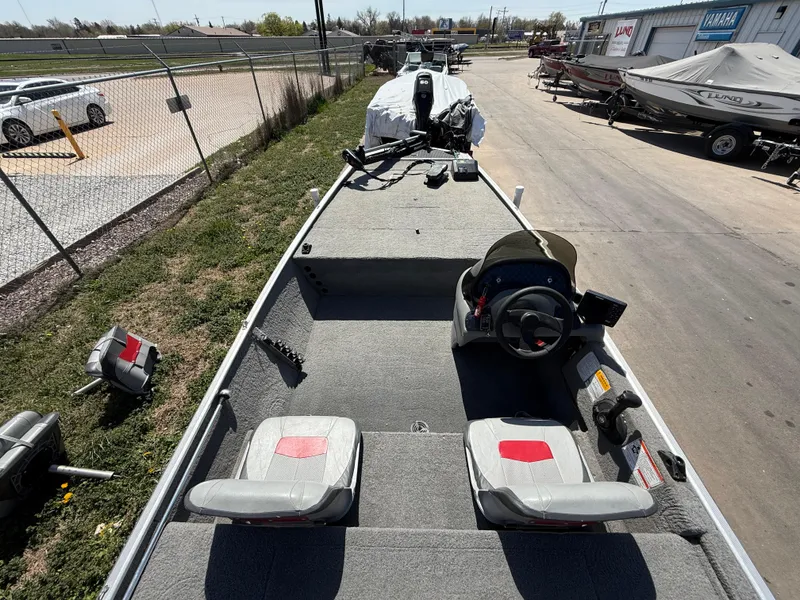 Slide: The Image of 2011 Tracker Pro 165 boat with dual seats and steering console, parked outdoors. - 7