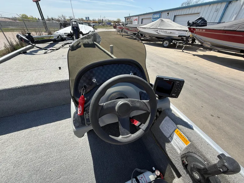 Slide: The Image of 2011 Tracker Pro 165 boat dashboard with steering wheel and navigation equipment. - 8