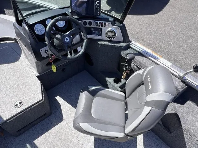 Slide: The Image of 2023 Lund 1775 Impact XS Sport boat interior with steering wheel and seat. - 12