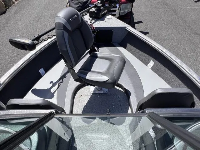 Slide: The Image of 2023 Lund 1775 Impact XS Sport boat interior with seating and steering console. - 15