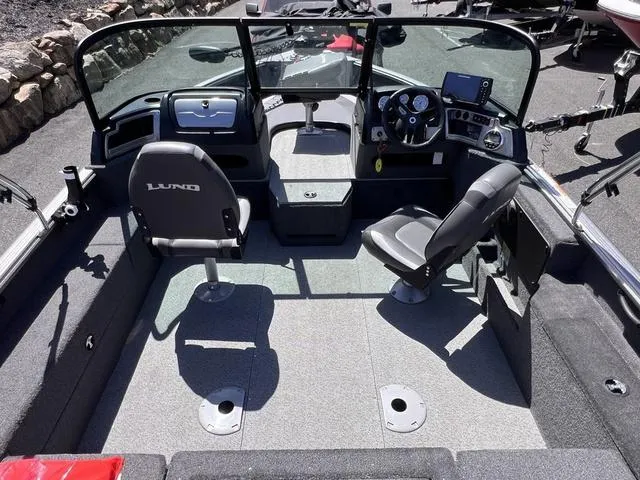 Slide: The Image of 2023 Lund 1775 Impact XS Sport boat interior with seating and dashboard. - 2