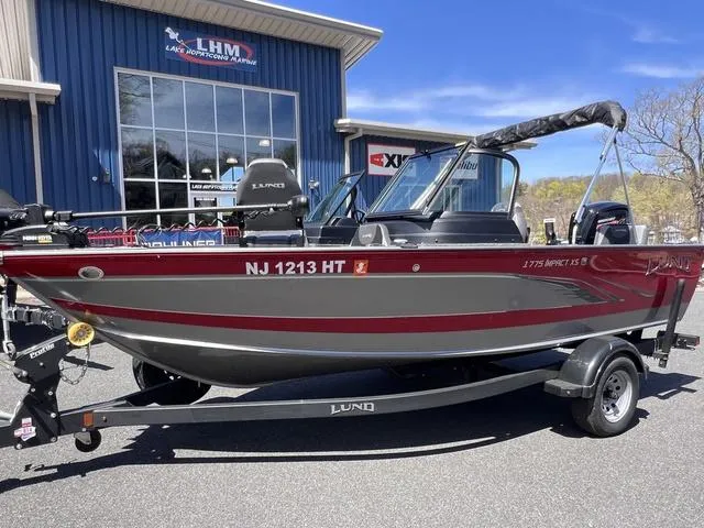 Slide: The Image of 2023 Lund 1775 Impact XS Sport boat on trailer, parked outside LHM building. - 3