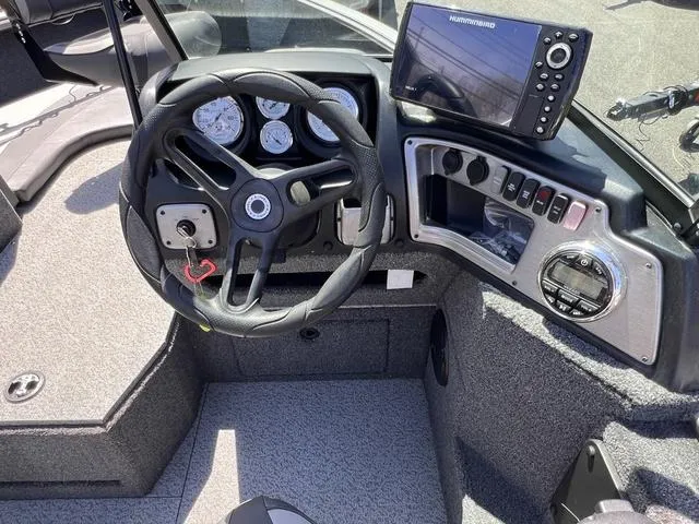Slide: The Image of 2023 Lund 1775 Impact XS Sport boat dashboard with steering wheel and navigation system. - 6