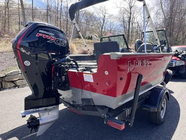 Slide: The Image of 2023 Lund 1775 Impact XS Sport boat with Mercury Pro XS engine, parked outdoors. - 8