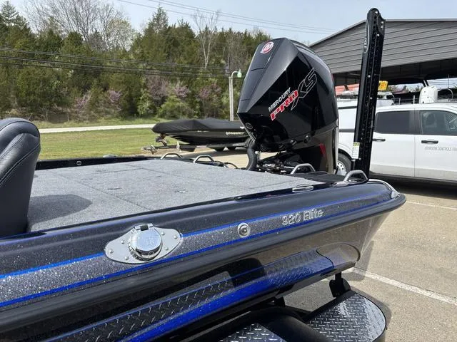 Slide: The Image of 2025 Phoenix 920 Elite boat with powerful engine, parked outdoors. - 11