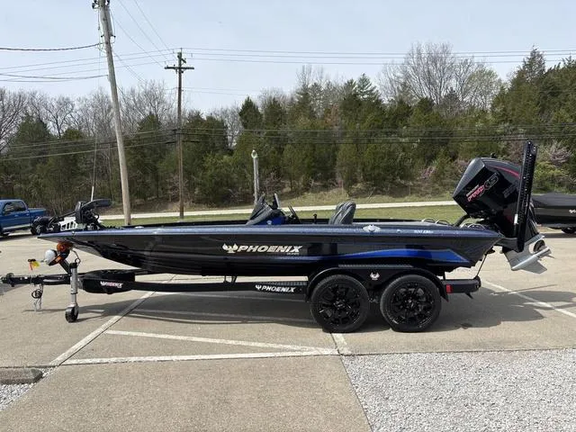 Slide: The Image of 2025 Phoenix 920 Elite boat on trailer, parked outdoors, side view. - 13