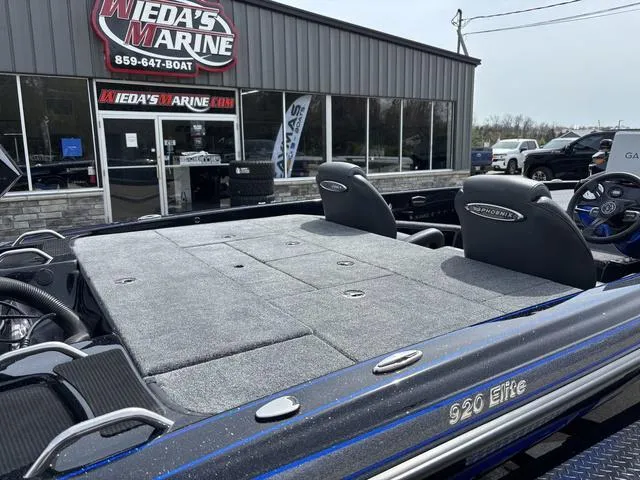 Slide: The Image of 2025 Phoenix 920 Elite boat at Weda's Marine dealership, showcasing sleek design and seating. - 4