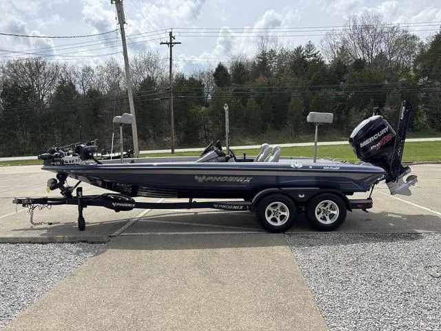 Slide: The Image of 2015 Phoenix 920 PRO XP boat on trailer, parked outdoors, featuring Mercury engine. - 15
