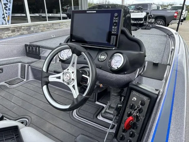 Slide: The Image of Cockpit of 2015 Phoenix 920 PRO XP boat with steering wheel and navigation display. - 5