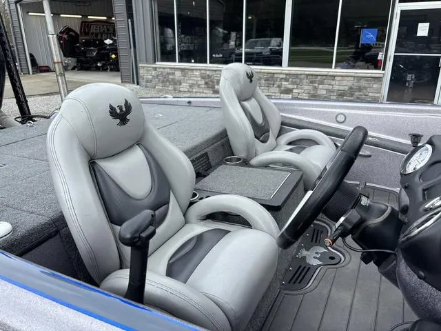 Slide: The Image of Interior of a 2015 Phoenix 920 PRO XP boat with gray seating and steering console. - 6