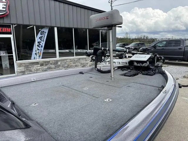 Slide: The Image of 2015 Phoenix 920 PRO XP boat with trolling motor, parked outside a showroom. - 7