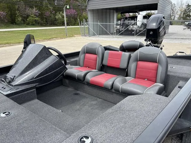 Slide: The Image of 2018 Ranger RT178 boat with red and gray seating, parked outdoors. - 10