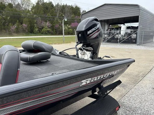 Slide: The Image of 2018 Ranger RT178 boat with Mercury engine, parked near a metal shed. - 11