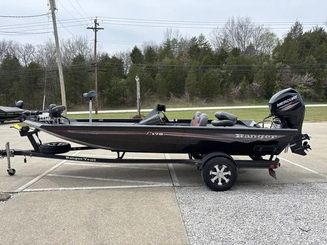 Slide: The Image of 2018 Ranger RT178 fishing boat on trailer with Mercury outboard motor, parked outdoors. - 13