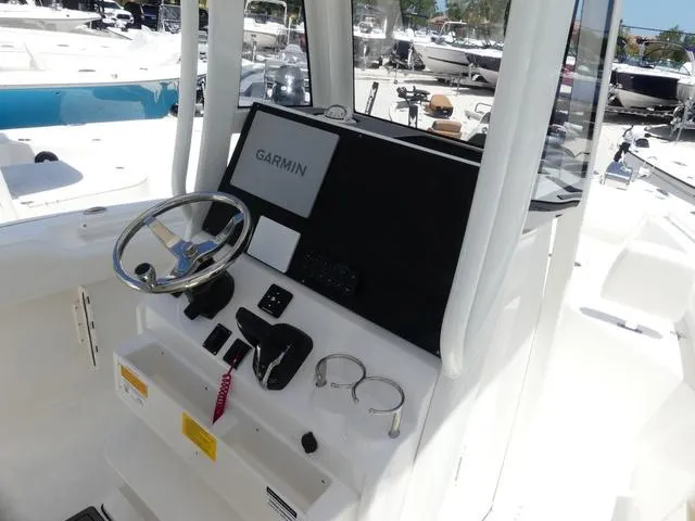 Slide: The Image of 2025 Key West 239 FSR boat console with Garmin navigation system and steering wheel. - 11