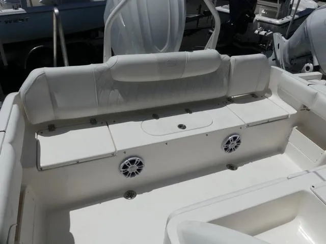 Slide: The Image of 2025 Key West 239 FSR boat interior with white seating and built-in speakers. - 14