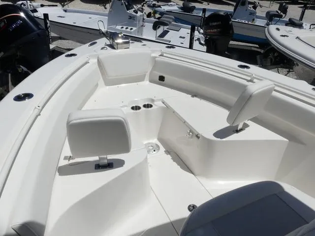 Slide: The Image of 2025 Key West 239 FSR boat interior with white seating and cup holders. - 16