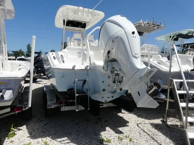 Slide: The Image of 2025 Key West 239 FSR boat with powerful outboard motor, displayed on gravel lot. - 4