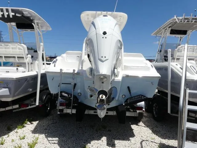 Slide: The Image of 2025 Key West 239 FSR boat, rear view, displayed outdoors on gravel. - 5