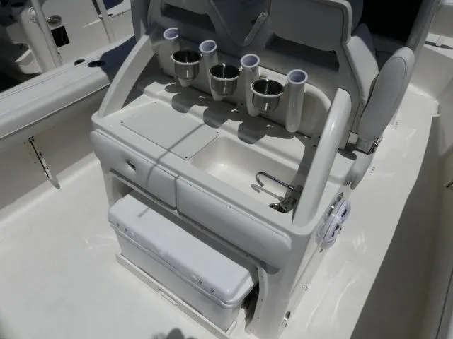 Slide: The Image of 2025 Key West 239 FSR boat console with cup holders and storage compartments. - 8