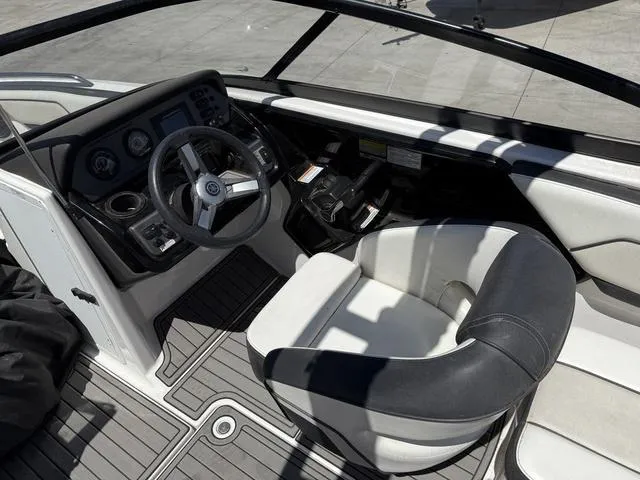 Slide: The Image of 2017 Yamaha Boats AR210 cockpit with steering wheel and captain's chair. - 10