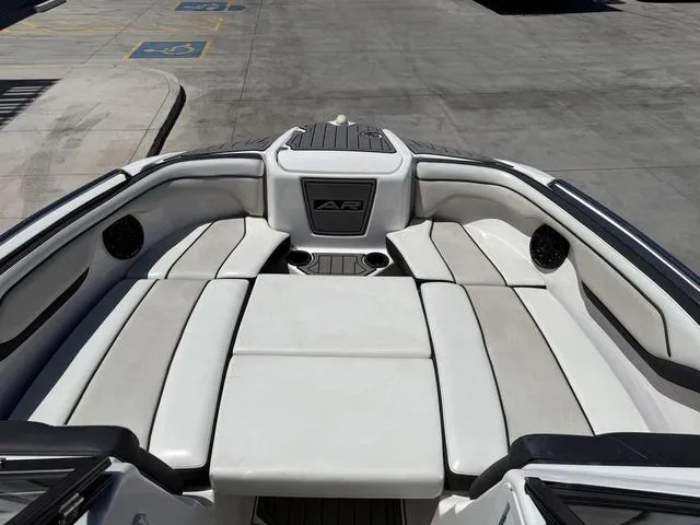 Slide: The Image of 2017 Yamaha AR210 boat interior with cushioned seating and cup holders. - 11