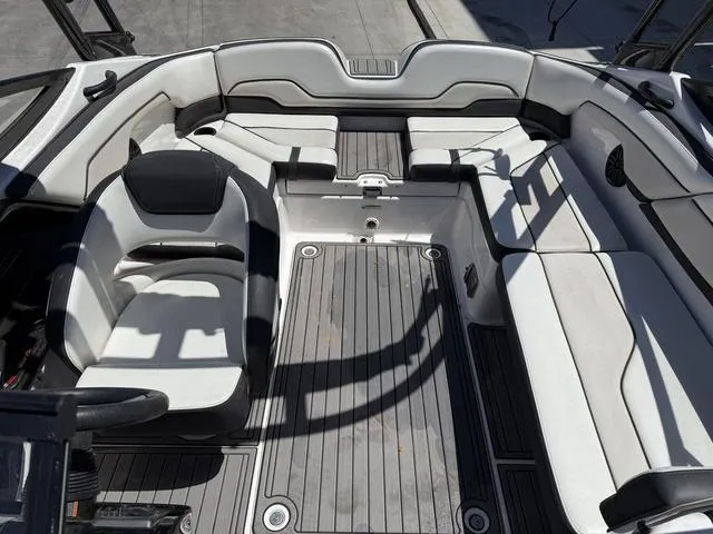 Slide: The Image of 2017 Yamaha AR210 boat interior with white seating and gray flooring. - 8