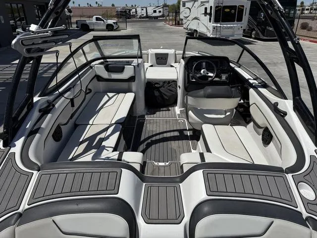 Slide: The Image of 2017 Yamaha Boats AR210 interior with sleek seating and modern dashboard design. - 9