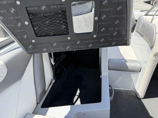 Slide: The Image of 2015 Tigé Z3 boat interior with storage compartment and seating. - 11