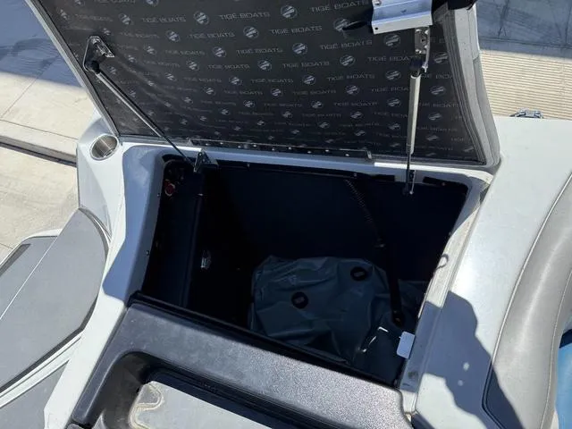 Slide: The Image of Open storage compartment in a 2015 Tigé Z3 boat, showing interior details. - 13