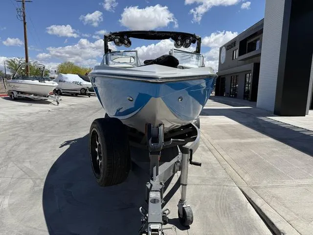 Slide: The Image of 2015 Tigé Z3 boat on trailer, parked outdoors under a blue sky. - 3