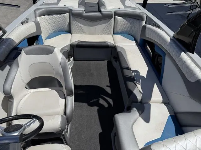 Slide: The Image of Interior of a 2015 Tigé Z3 boat with white and blue seating. - 8