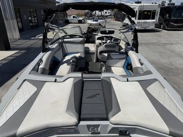 Slide: The Image of 2015 Tigé Z3 boat interior with seating and dashboard, parked outdoors. - 9