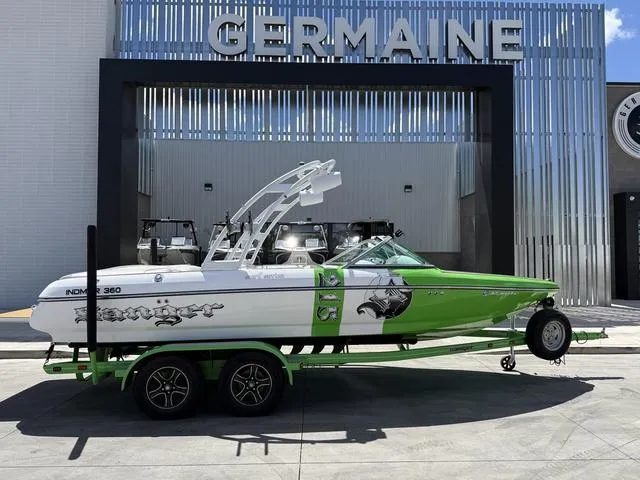 Slide: The Image of 2016 Sanger 215S boat in green and white on a trailer outside Germaine dealership. - 1