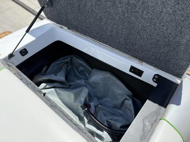 Slide: The Image of Open storage compartment in 2016 Sanger 215S boat with gray interior. - 13