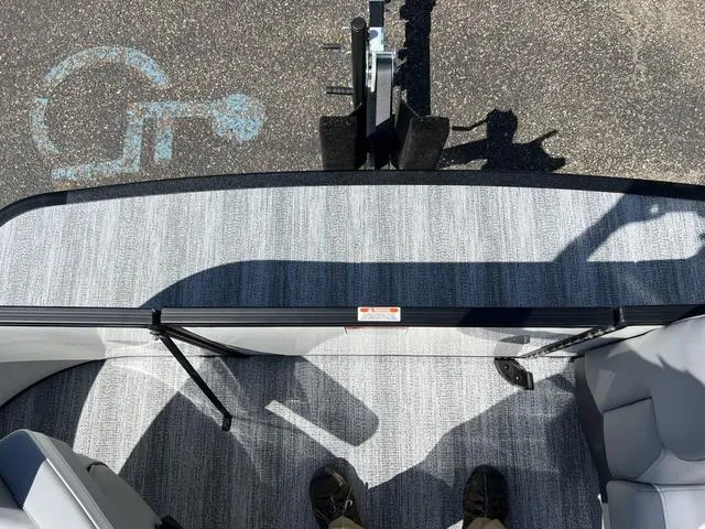 Slide: The Image of 2025 Bennington 22 SSR PTG pontoon boat interior with gray flooring and seating. - 10