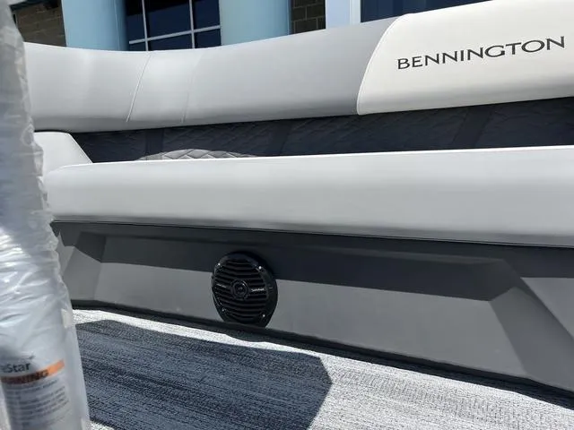 Slide: The Image of 2025 Bennington 22 SSR PTG boat interior with sleek seating and speaker detail. - 16