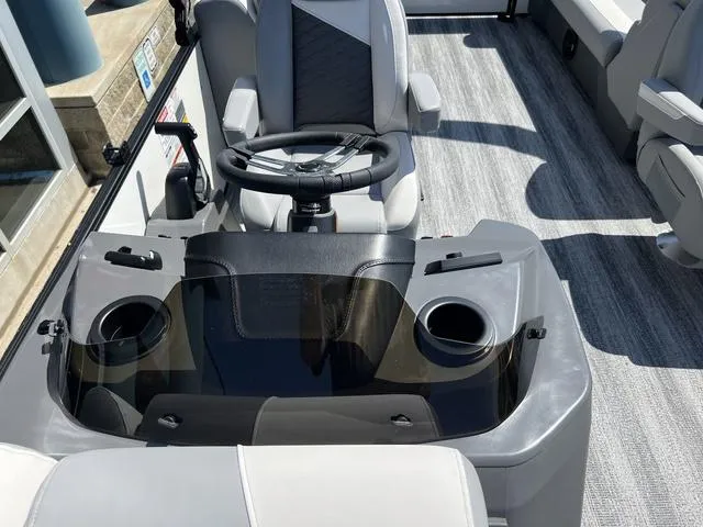 Slide: The Image of 2025 Bennington 22 SSR PTG boat console with steering wheel and cup holders. - 18