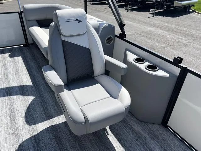 Slide: The Image of Luxurious seating on 2025 Bennington 22 SSR PTG pontoon boat with modern design and cup holders. - 19