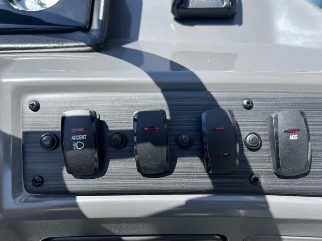 Slide: The Image of Dashboard switches of a 2025 Bennington 22 SSR PTG boat, featuring accent and accessory controls. - 28