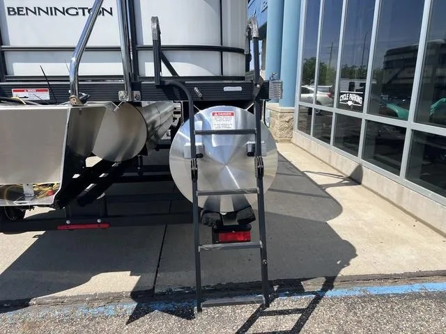 Slide: The Image of 2025 Bennington 22 SSR PTG pontoon boat rear view with ladder and propeller. - 3