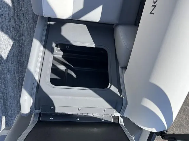 Slide: The Image of 2025 Bennington 22 SSR PTG boat seat storage compartment, open and empty. - 35