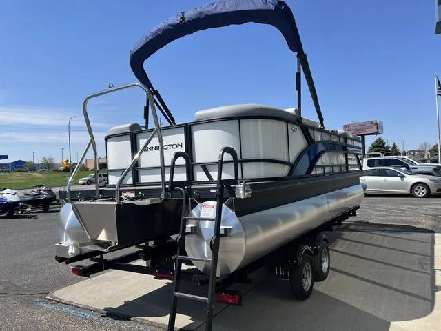 Slide: The Image of 2025 Bennington 22 SSR PTG pontoon boat on trailer, parked outdoors. - 5