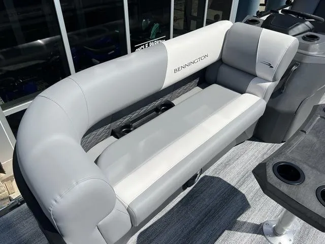 Slide: The Image of 2025 Bennington 22 SSR PTG boat seating with gray upholstery and cup holders. - 8