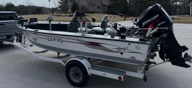 Slide: The Image of 2003 Lund 2025 Pro-V Magnum SE boat on trailer with Mercury outboard motor. - 3