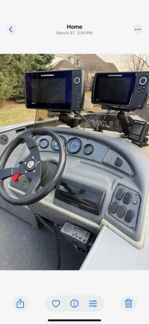Slide: The Image of 2003 Lund 2025 Pro-V Magnum SE boat dashboard with dual fish finders and steering wheel. - 5