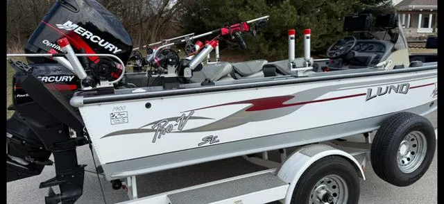 Slide: The Image of 2003 Lund 2025 Pro-V Magnum SE boat on trailer with Mercury outboard motor. - 7