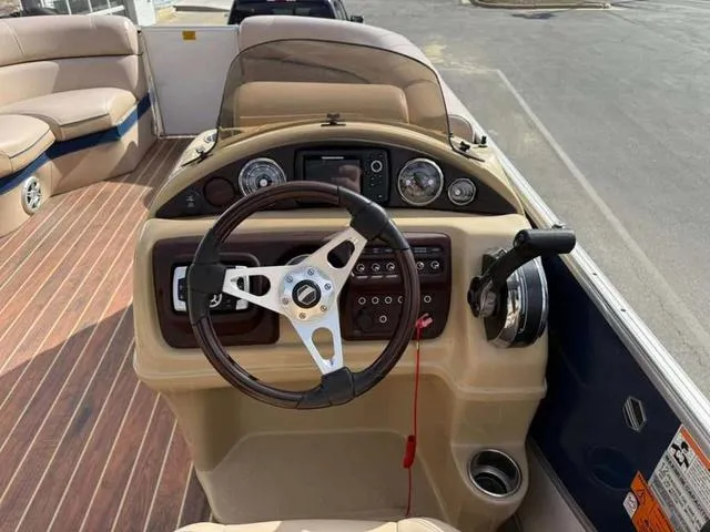 Slide: The Image of 2016 South Bay 523FCR 2.75 boat dashboard with steering wheel and controls. - 10