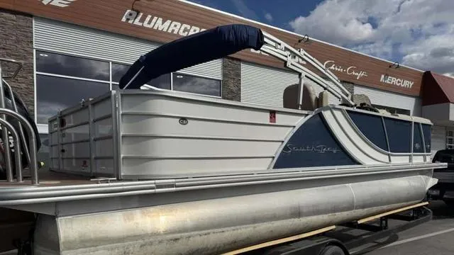 Slide: The Image of 2016 South Bay 523FCR 2.75 pontoon boat parked outside a dealership. - 3
