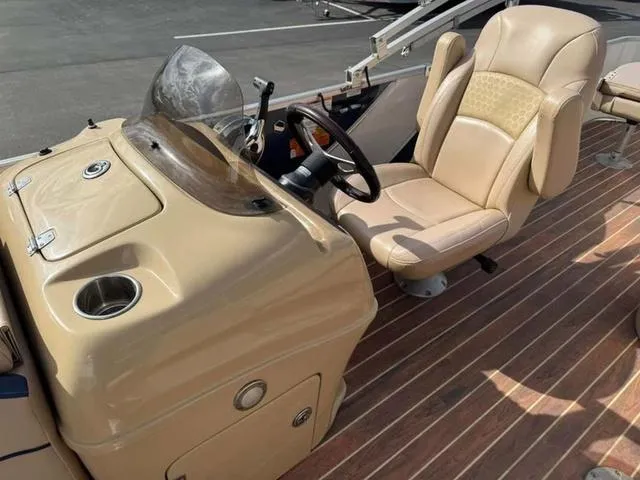 Slide: The Image of 2016 South Bay 523FCR 2.75 boat interior with beige captain's chair and control panel. - 9